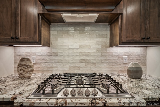 3828 W Orlando St, Broken Arrow, OK 74011 - kitchen featuring stainless steel gas stovetop, dark brown cabinets, tasteful backsplash, and light stone counters