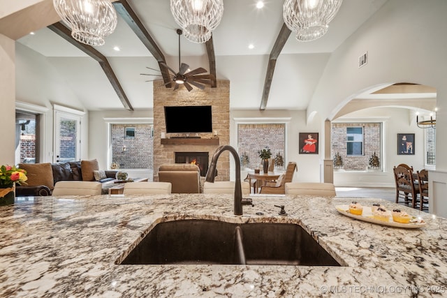 3828 W Orlando St, Broken Arrow, OK 74011 - kitchen with a chandelier, open floor plan, a sink, light stone countertops, and ceiling fan