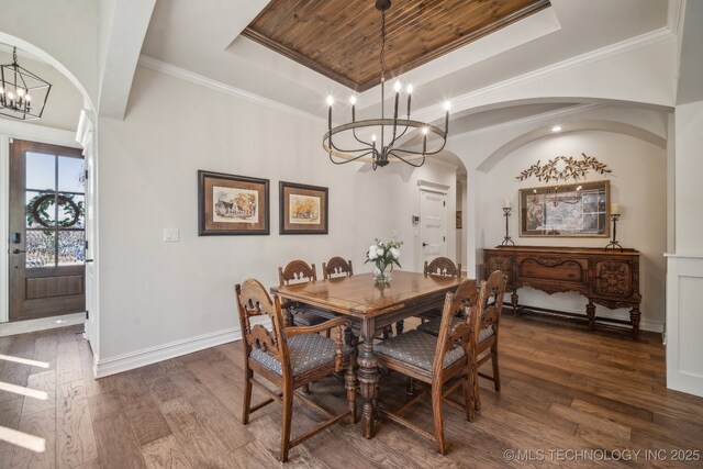 3828 W Orlando St, Broken Arrow, OK 74011 - dining area featuring a chandelier, arched walkways, a raised ceiling, dark wood-style floors, and crown molding