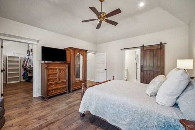 3828 W Orlando St, Broken Arrow, OK 74011 - bedroom featuring a barn door, wood finished floors, a spacious closet, a closet, and high vaulted ceiling