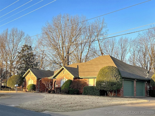 view of side of home featuring brick siding and concrete driveway