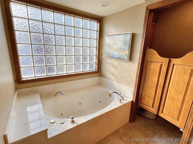 full bathroom with a jetted tub and tile patterned flooring