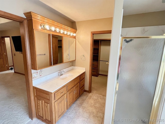 bathroom featuring a shower stall, vanity, and baseboards