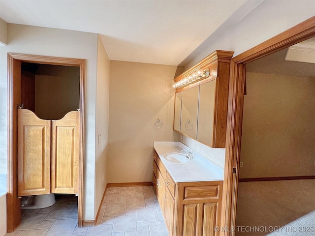 bathroom with baseboards and vanity