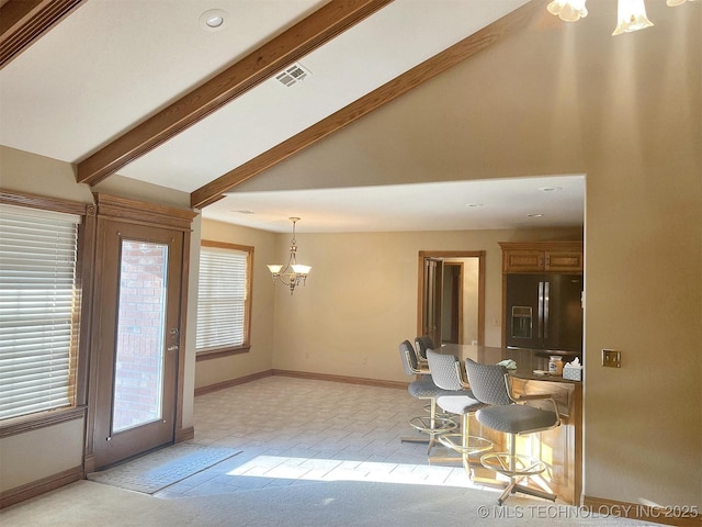 unfurnished dining area with visible vents, beamed ceiling, a chandelier, and a healthy amount of sunlight