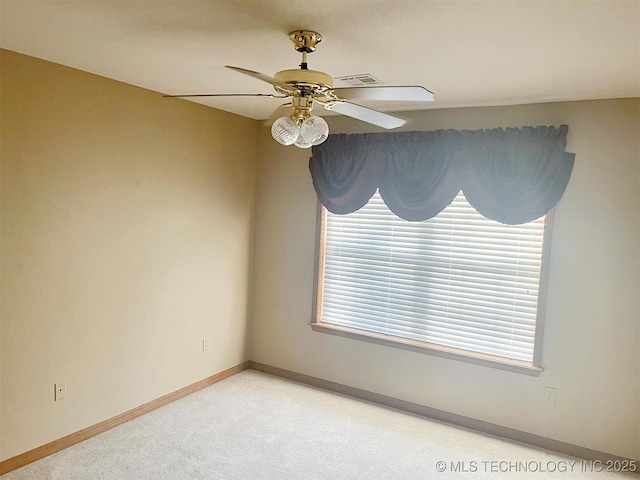 spare room featuring visible vents, baseboards, light colored carpet, and a ceiling fan