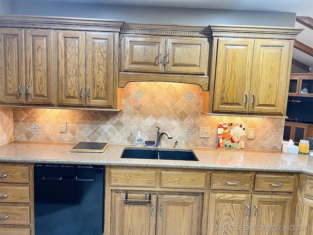 kitchen with decorative backsplash, black dishwasher, light stone countertops, and a sink