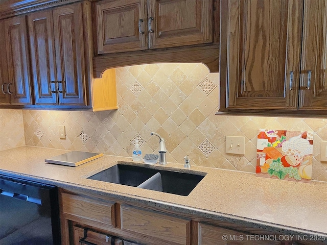 kitchen with a sink, tasteful backsplash, dishwasher, and dark brown cabinets