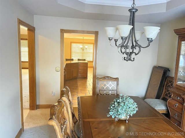 dining room with an inviting chandelier and baseboards