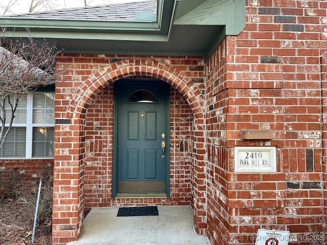 entrance to property with brick siding