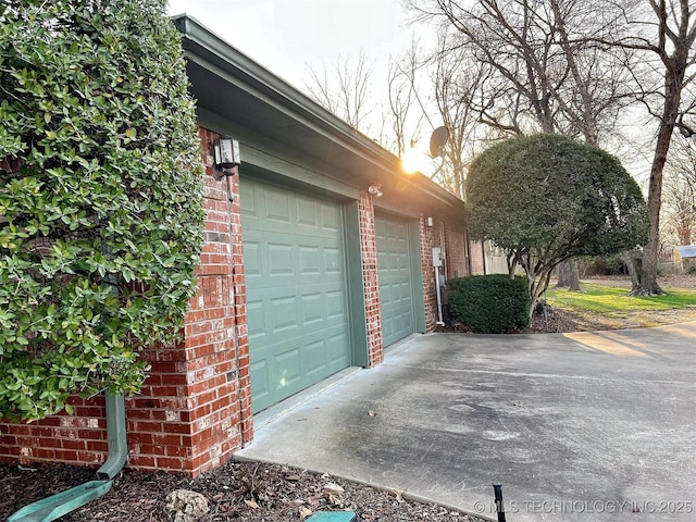 garage featuring concrete driveway