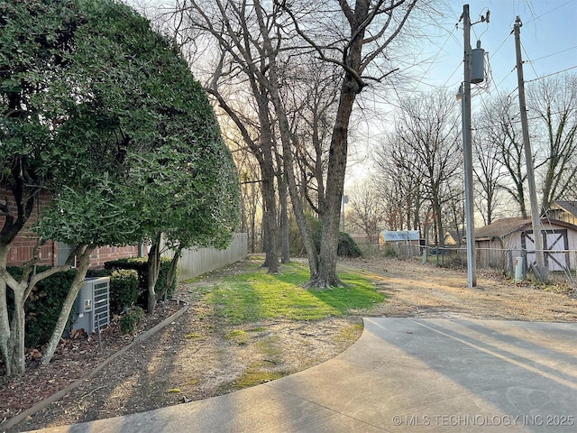 view of yard with cooling unit and fence