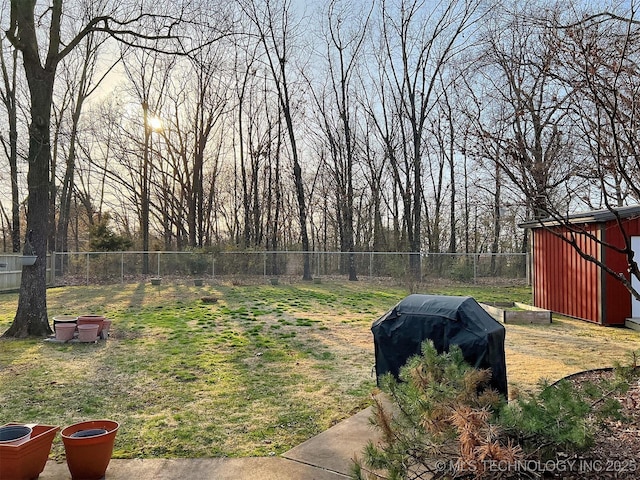 view of yard featuring an outdoor structure, a storage shed, and a fenced backyard