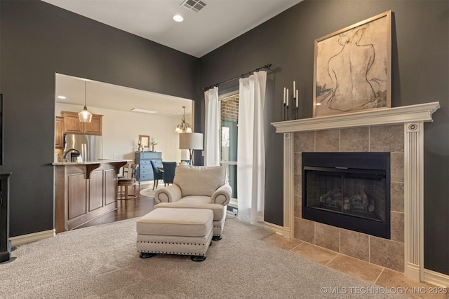 interior space featuring visible vents, recessed lighting, carpet, a fireplace, and baseboards