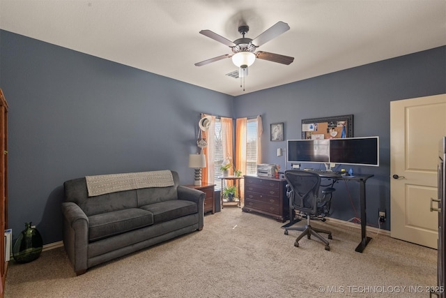 office area with baseboards, carpet floors, and ceiling fan