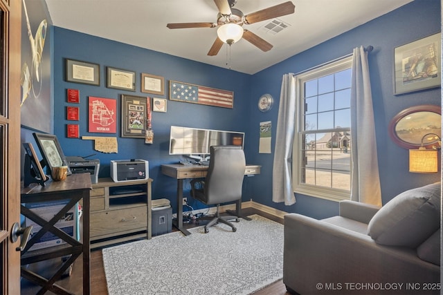 office featuring visible vents, baseboards, ceiling fan, and wood finished floors