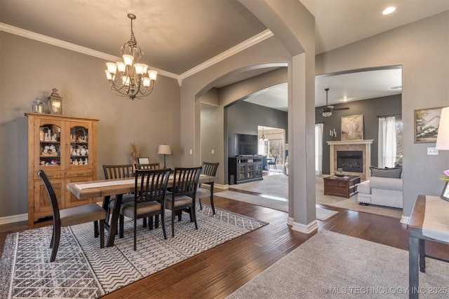 dining room featuring hardwood / wood-style flooring, baseboards, and a tile fireplace