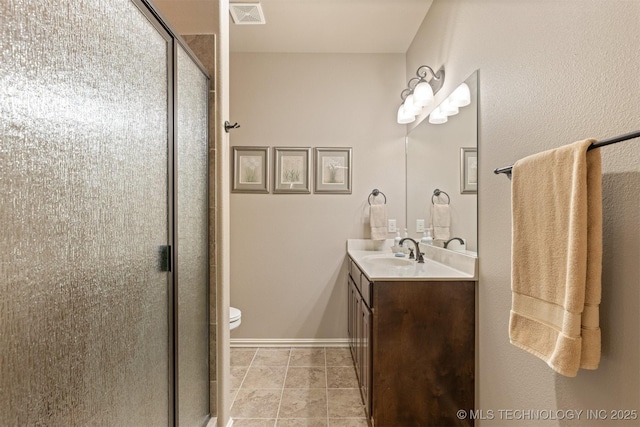 bathroom with visible vents, a stall shower, and vanity