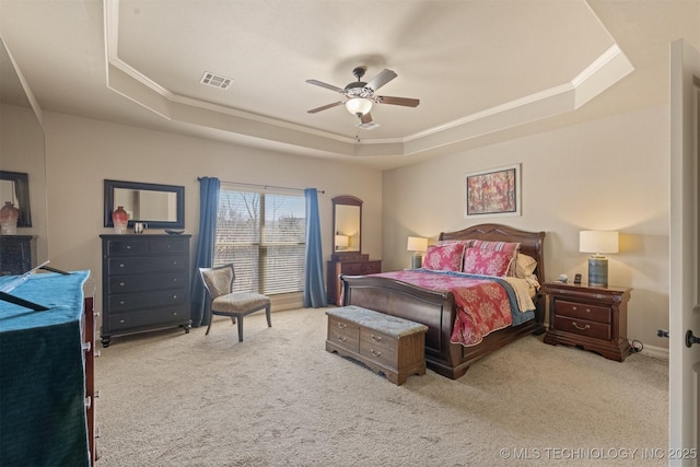 bedroom with visible vents, carpet flooring, and a raised ceiling