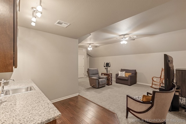 living room with visible vents, dark wood-type flooring, a ceiling fan, baseboards, and lofted ceiling