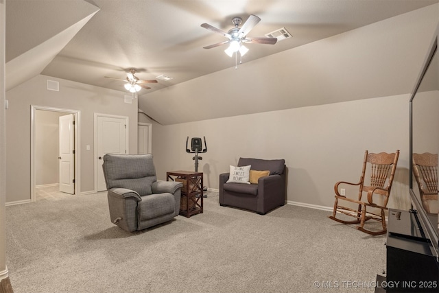 sitting room featuring visible vents, a ceiling fan, baseboards, carpet flooring, and lofted ceiling