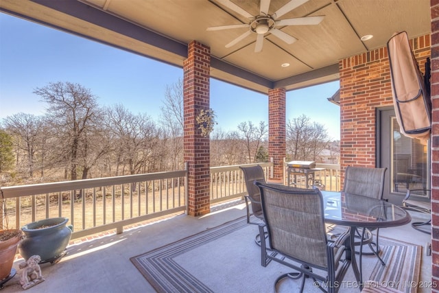 deck featuring outdoor dining area and ceiling fan