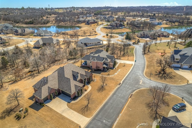 bird's eye view featuring a water view and a residential view