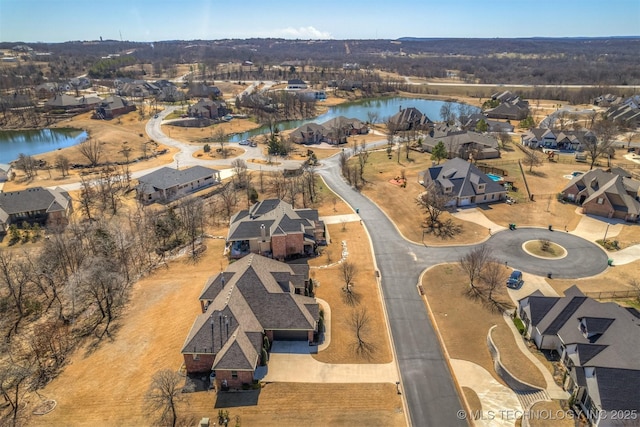 drone / aerial view with a water view and a residential view