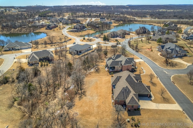 bird's eye view with a water view and a residential view