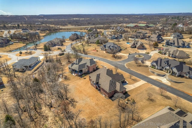 drone / aerial view featuring a residential view and a water view