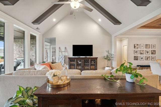 living room featuring a ceiling fan, visible vents, and high vaulted ceiling