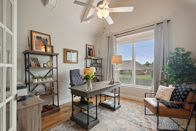 office space with wood finished floors, a ceiling fan, baseboards, and vaulted ceiling