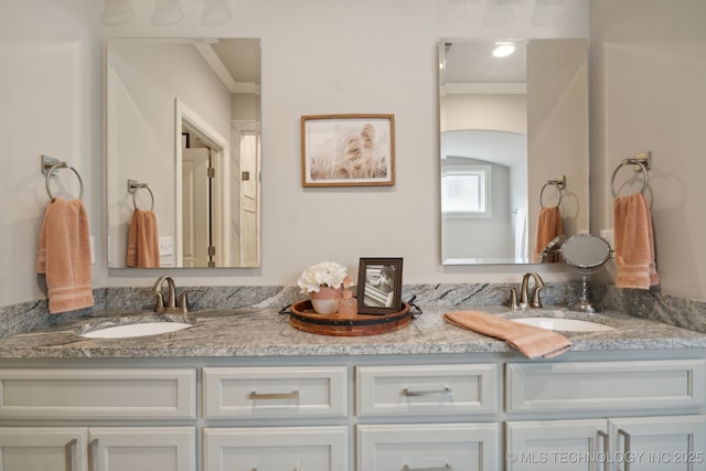 bathroom with double vanity, ornamental molding, and a sink