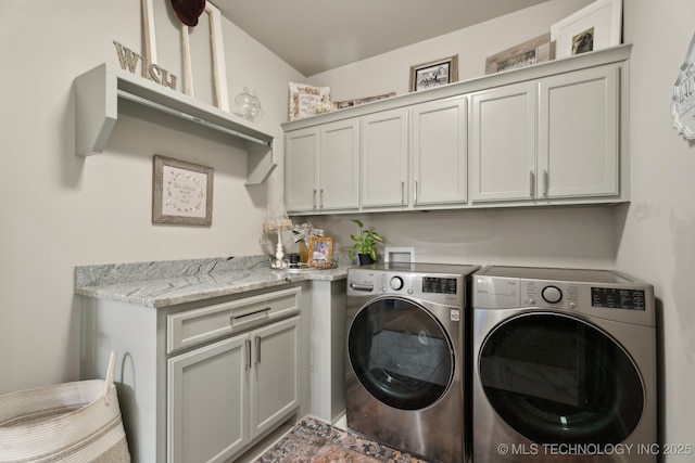 laundry area with washer and dryer and cabinet space