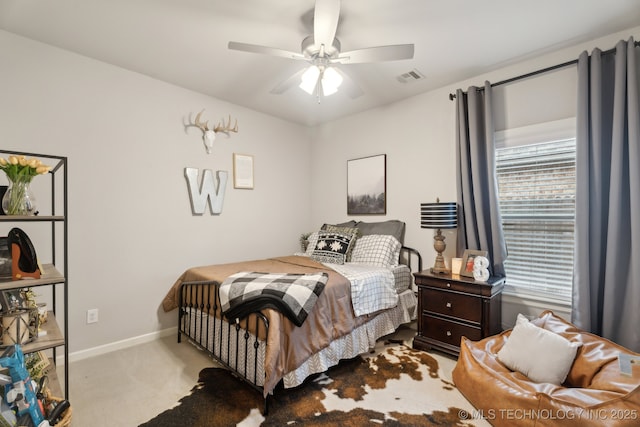 bedroom with visible vents, baseboards, carpet, and ceiling fan