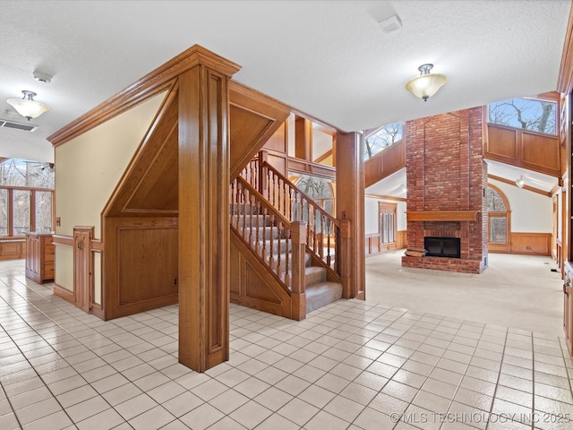 unfurnished living room featuring visible vents, a brick fireplace, and a textured ceiling