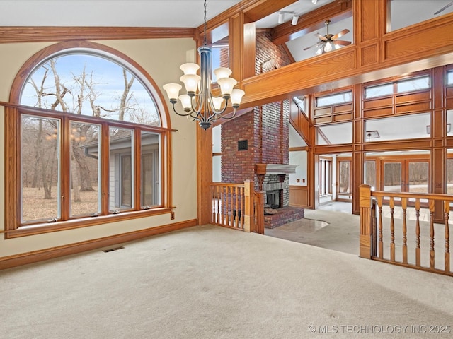 unfurnished living room with visible vents, high vaulted ceiling, carpet flooring, baseboards, and a brick fireplace