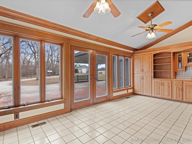 unfurnished sunroom with visible vents, lofted ceiling, a ceiling fan, and french doors