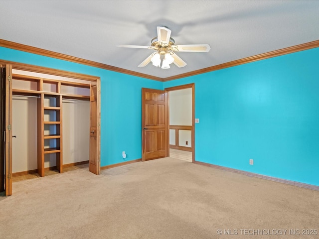 unfurnished bedroom featuring baseboards, carpet, ornamental molding, a closet, and a ceiling fan