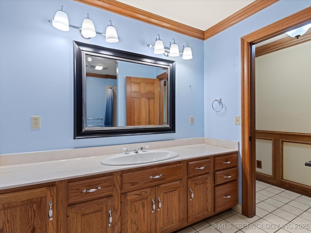 bathroom with tile patterned flooring, vanity, and crown molding