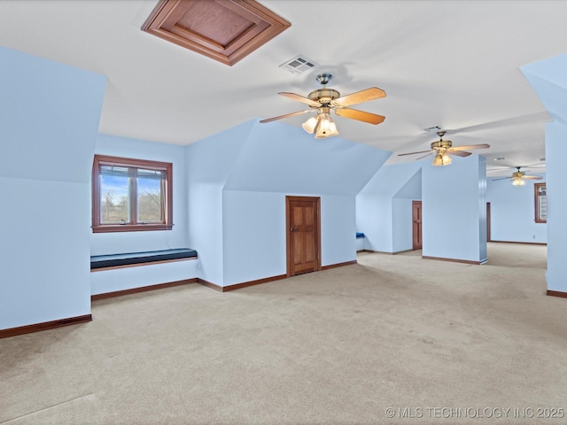 additional living space featuring visible vents, carpet flooring, baseboards, and vaulted ceiling