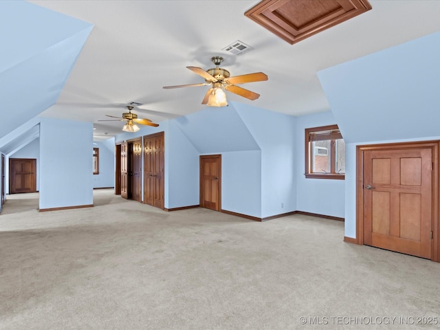 bonus room with visible vents, light carpet, baseboards, and vaulted ceiling