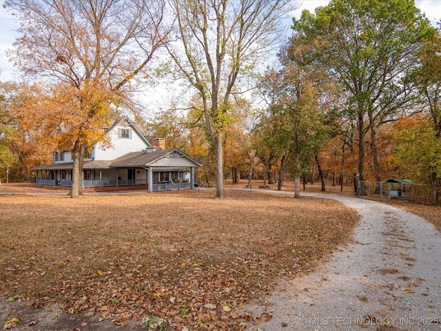 view of front of house featuring a porch and a chimney