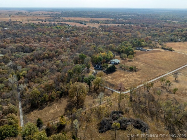 drone / aerial view featuring a rural view and a wooded view