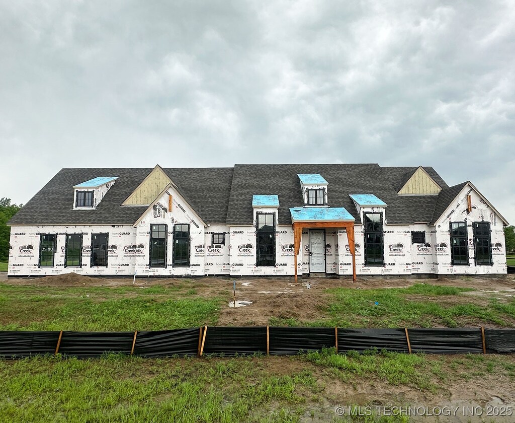 2580 Cross Creek Dr, Oologah, OK 74053 - property under construction featuring roof with shingles and fence
