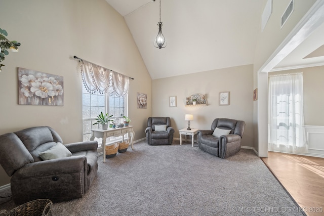 carpeted living room featuring visible vents and high vaulted ceiling