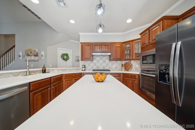 kitchen with visible vents, under cabinet range hood, backsplash, appliances with stainless steel finishes, and light countertops