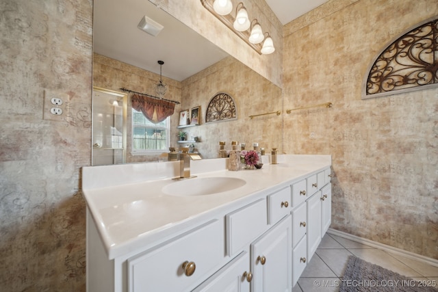 full bath featuring tile patterned flooring, double vanity, and a sink