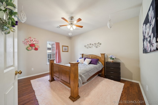 bedroom with a ceiling fan, baseboards, and dark wood-style flooring