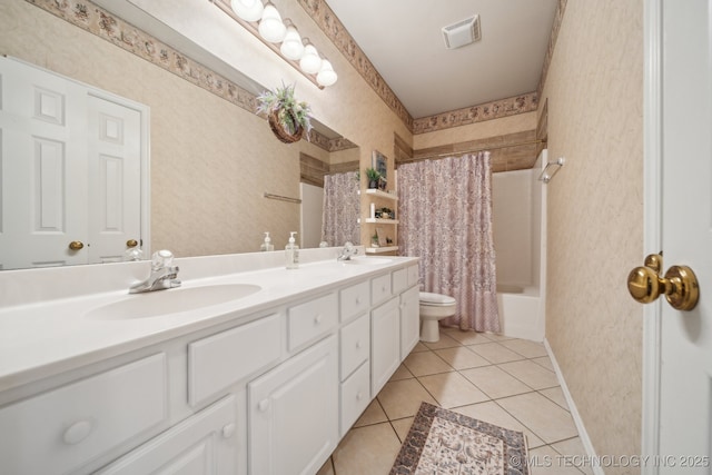 bathroom with visible vents, wallpapered walls, and a sink